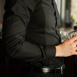Men's Work Shirt close-up showing slim fit, black fabric, and stain-resistant, sweat-proof design with long sleeves.