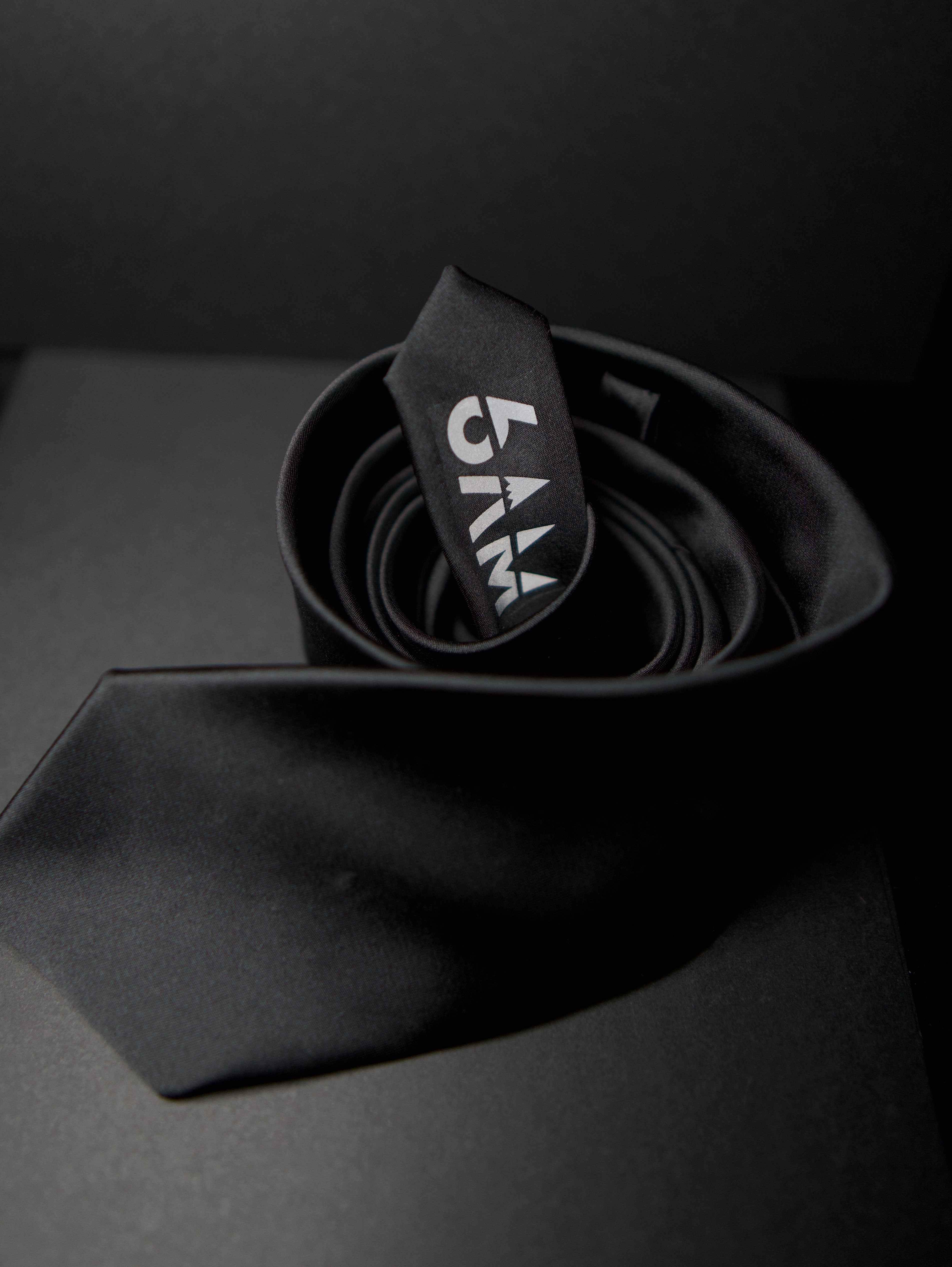 6AM Formal Black Tie in black with 6AM logo on the tail, perfect pairing for the 6AM WorkShirt.
