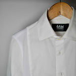 The front of a white sweatproof dress shirt for men on a wooden hanger
