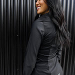 The side of a model wearing a black sweatproof dress shirt for women