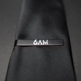 6AM Tie Clip handmade black stainless steel with 6AM logo engraved on a black tie close-up view