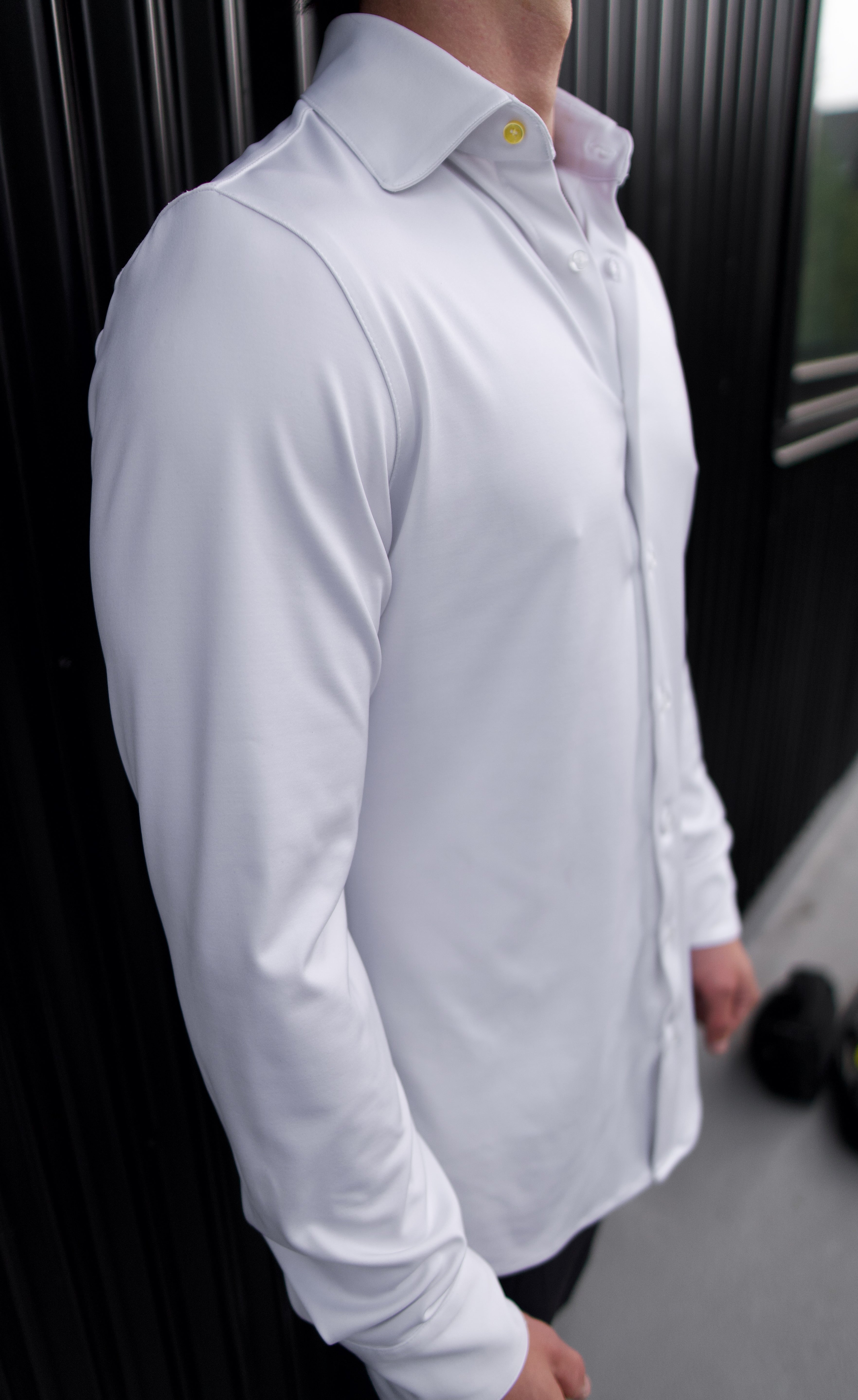 Man wearing a white Never-Iron Work Shirt highlighting its smooth, wrinkle-free fabric and tailored fit.