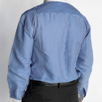 Person wearing a blue striped shirt and black pants on a white background
