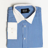 Folded blue and white striped shirt with a visible brand label on a light gray background