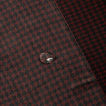 Close-up of water beading on the burgundy and black Bordeaux Arrowhead WorkShirt performance fabric.