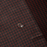 Close-up of water beading on the burgundy and black Bordeaux Arrowhead WorkShirt performance fabric.