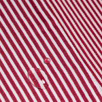 Close-up of red and white striped fabric with a water droplet.