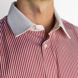 Close-up of a red and white striped shirt with a collar.