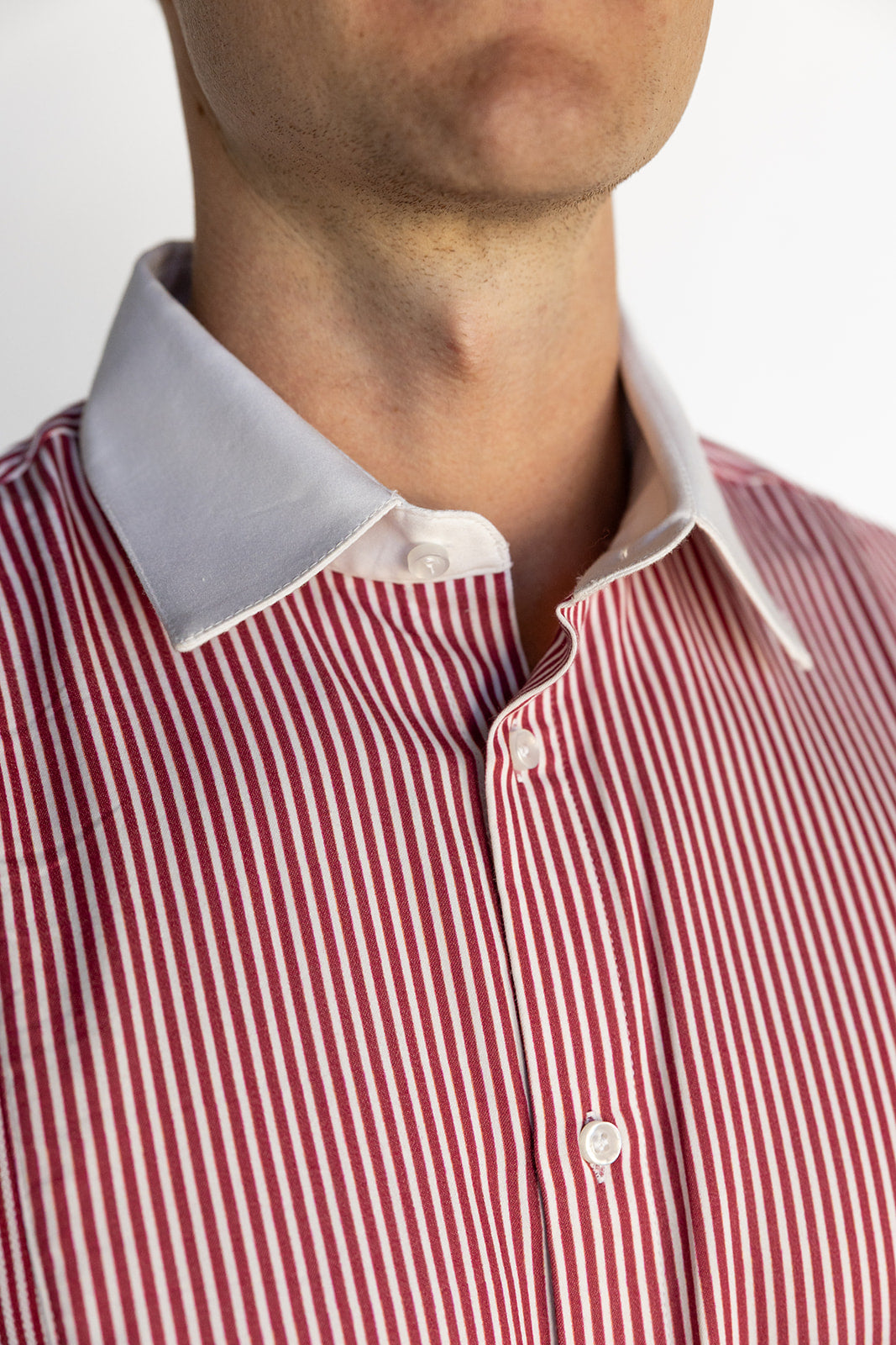 Close-up of a red and white striped shirt with a collar.