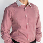 Man wearing a red and white striped dress shirt with a plain background