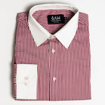 Folded red and white striped shirt with a visible brand label on a light gray background