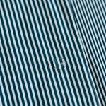 Close-up of a water droplet on a green and white striped fabric surface