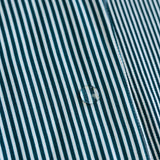 Close-up of a water droplet on a green and white striped fabric surface