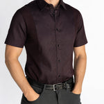 Man wearing the short-sleeve Bordeaux Arrowhead WorkShirt in a deep burgundy and black geometric pattern, front detail view.