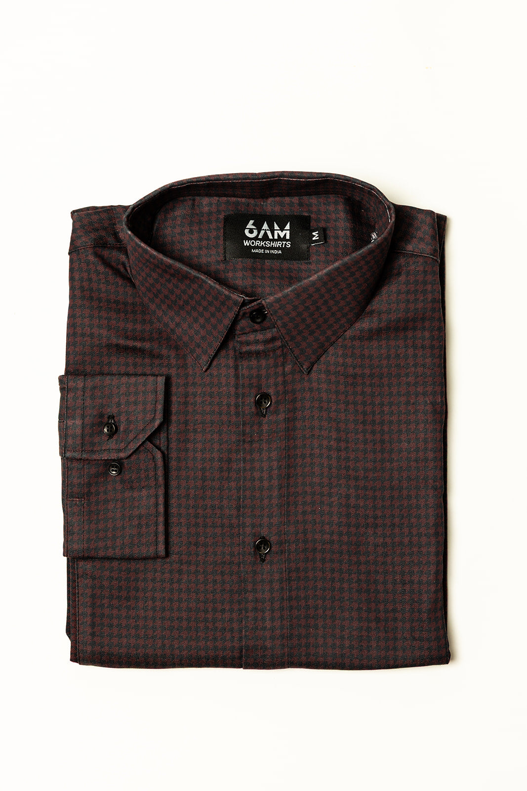 Folded Long Sleeve Women’s Bordeaux Arrowhead WorkShirt in a burgundy and black geometric pattern with collar and cuff visible.