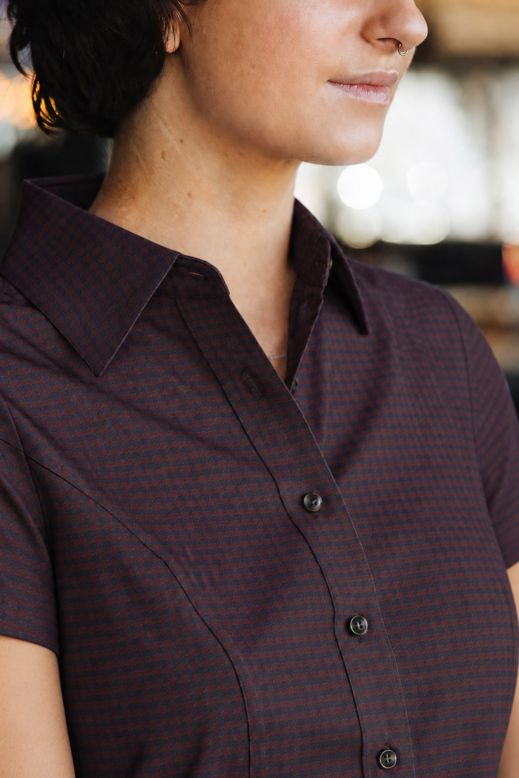 Close-up of the Women’s short-sleeve Bordeaux Arrowhead WorkShirt showing the collar, buttons and geometric pattern.