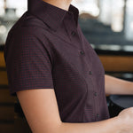 Side view of the Women’s short-sleeve Bordeaux Arrowhead WorkShirt showing the burgundy and black pattern and tailored fit.