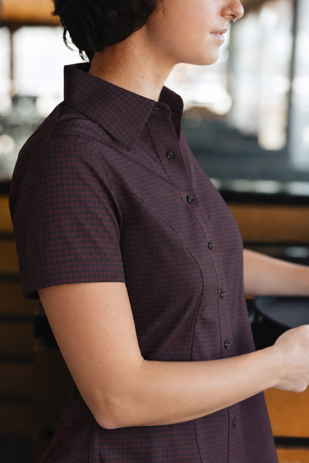 Side view of the Women’s short-sleeve Bordeaux Arrowhead WorkShirt showing the burgundy and black pattern and tailored fit.