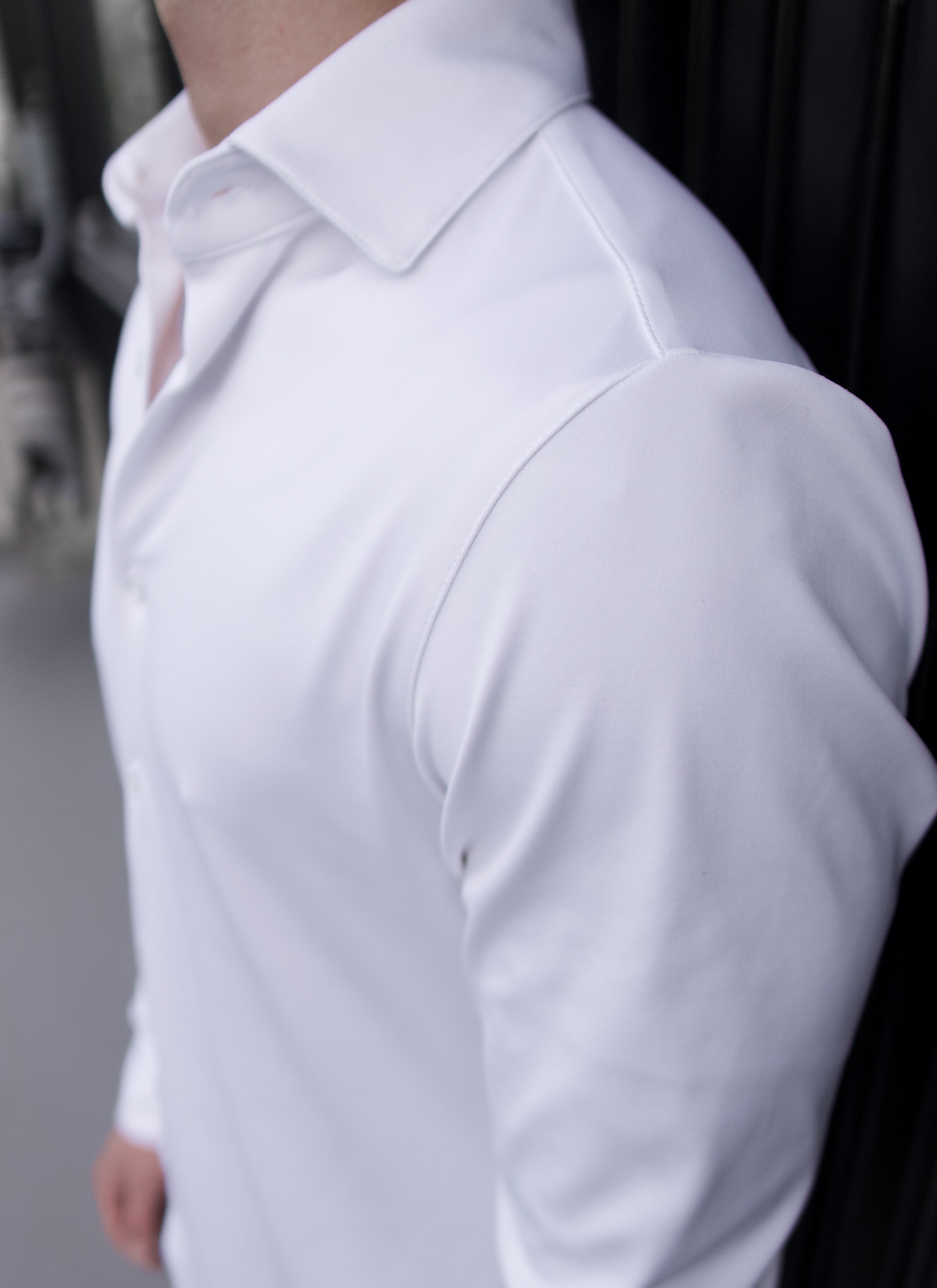 Close-up of a man wearing a white Never-Iron Work Shirt showcasing smooth fabric and comfortable fit.