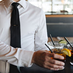 Man wearing a white Never-Iron Work Shirt serving drinks, showcasing its wrinkle-free and comfortable fit.