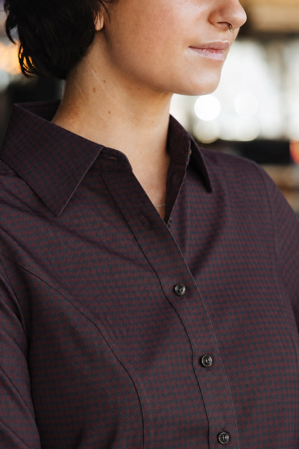 Close-up of the Women’s Bordeaux Arrowhead WorkShirt showing the collar, buttons and burgundy and black geometric pattern.