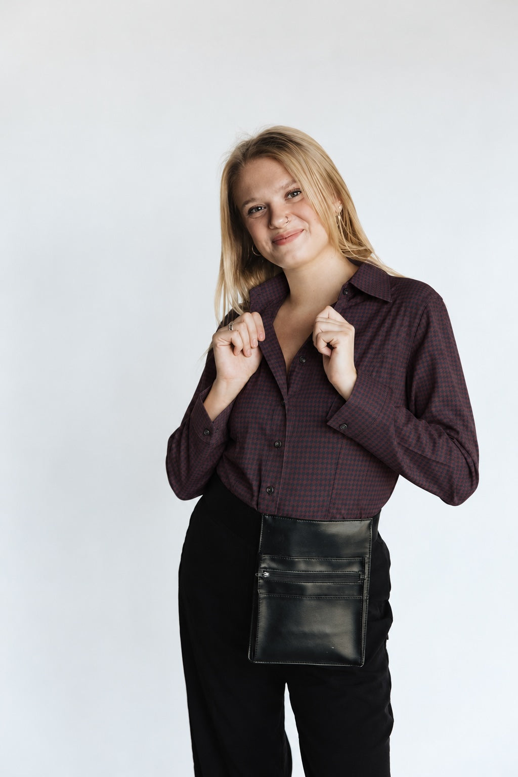 Woman wearing the Women’s Long Sleeve Bordeaux Arrowhead WorkShirt in a deep burgundy and black geometric pattern against a light background.