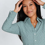Close front view of women’s emerald green hexagon-pattern long-sleeve WorkShirt with white buttons.