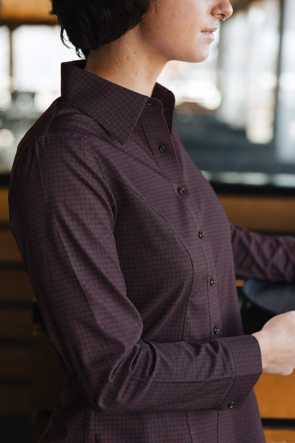 Side view of the Women’s Long Sleeve Bordeaux Arrowhead WorkShirt showing the burgundy and black geometric pattern and tailored fit.