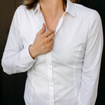 The front of a model wearing a white sweatproof dress shirt for women