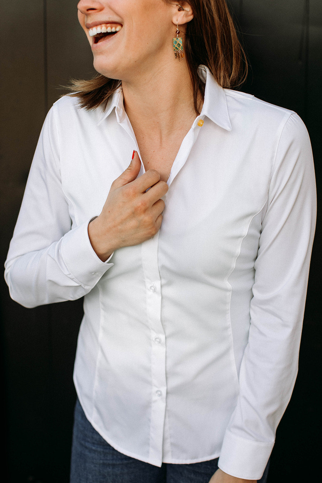 The front of a model wearing a white sweatproof dress shirt for women