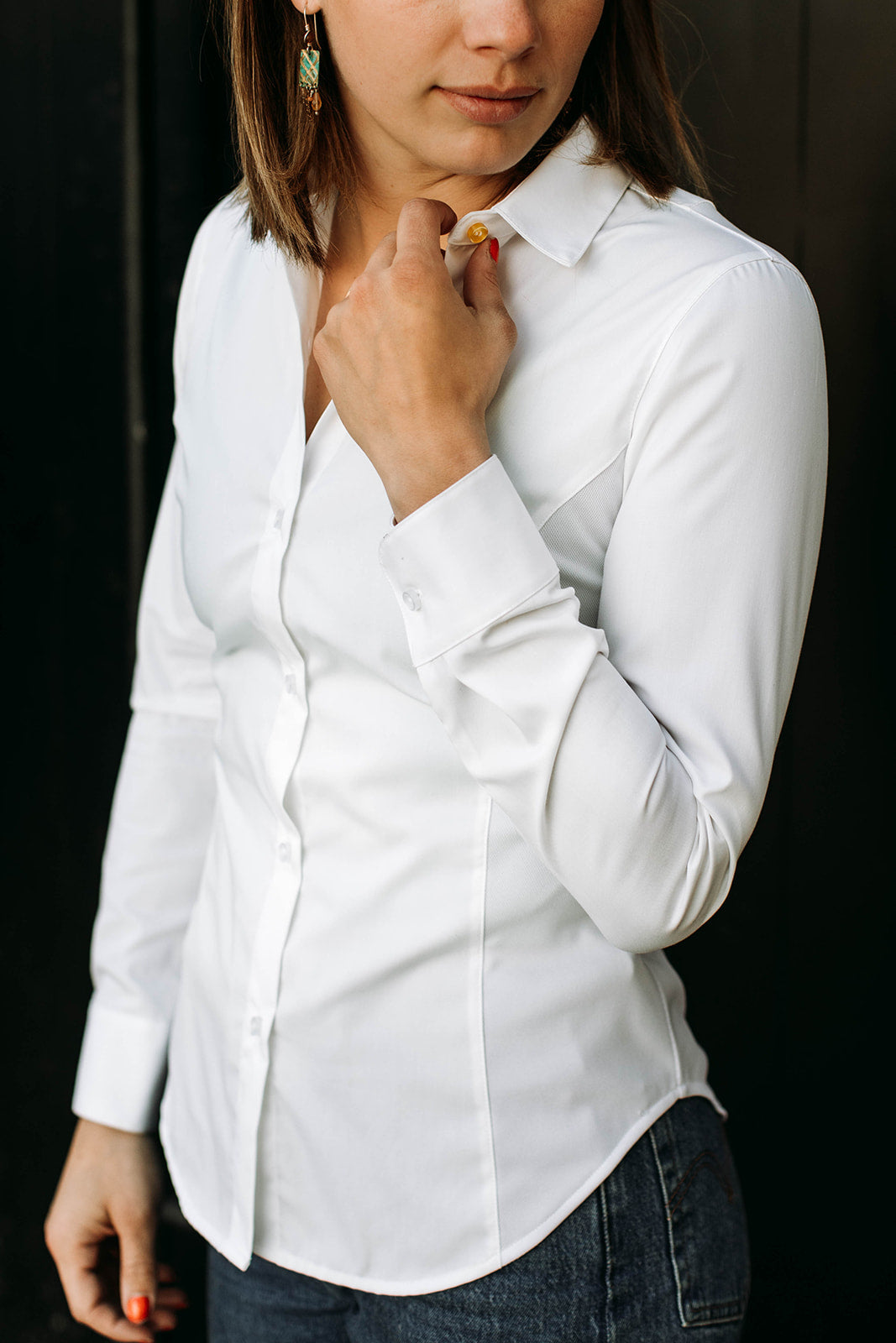 The side of a model wearing a white sweatproof dress shirt for women